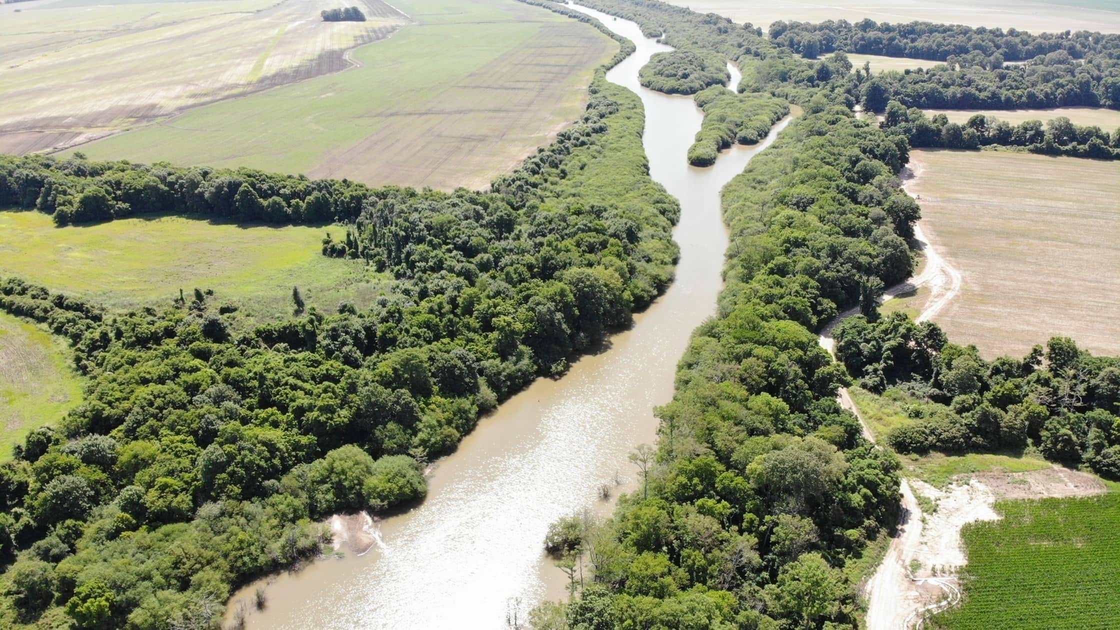 river runs through agricultural land for sale